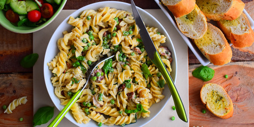 Creamy pea, bacon and brie pasta with salad and garlic bread