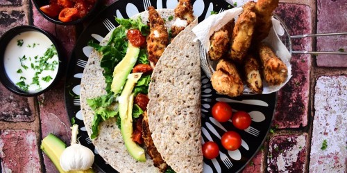 Chicken goujons in a wrap with roast tomatoes, fresh avocado and garlic mayo
