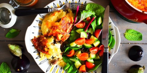 Traditional Lamb Moussaka served with a tomato and green salad