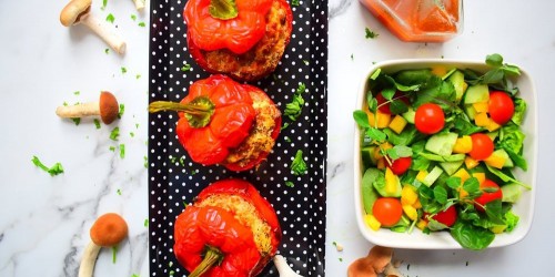 Veggie pearl barley stuffed peppers with mushroom, served with a tomato and green salad with pesto dressing