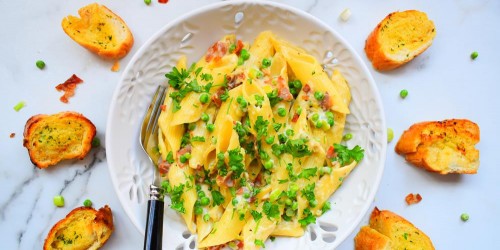 Bacon and pea pasta with a parmesan cream sauce, served with garlic bread