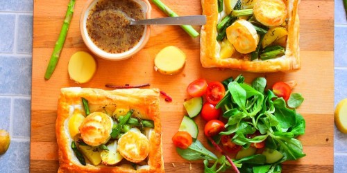 Asparagus puff pastry tart with goats cheese served with green salad and cherry tomatoes