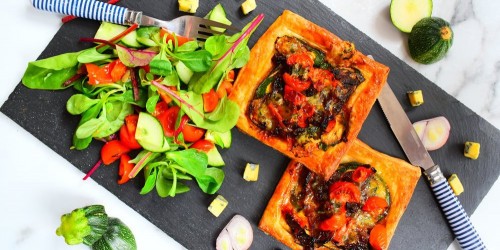 Courgette and tomato tart with blue cheese and a green salad