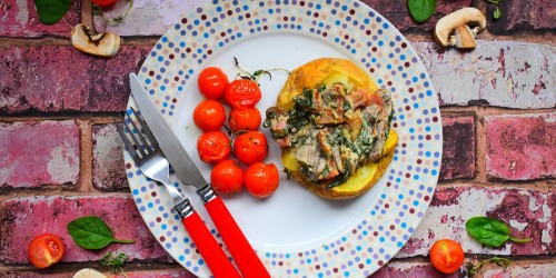 Baked potato with a bacon, spinach and mushroom creme fraiche and mustard filling, served with thyme roasted cherry tomatoes