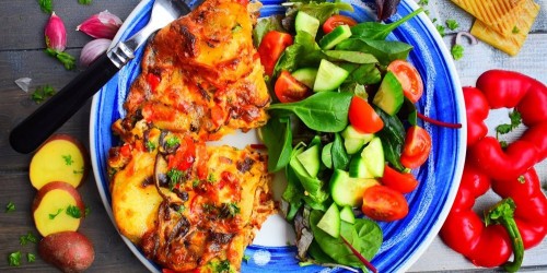 Veggie Spanish potato and onion tortilla with peppers and manchego served with a green salad with tomatoes