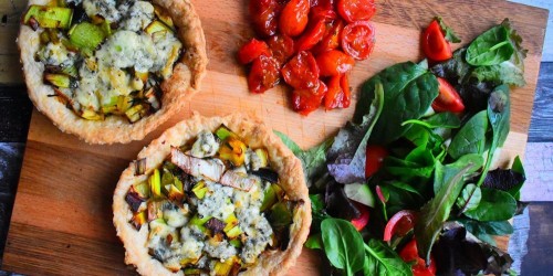Leek and blue cheese tart served with roasted tomatoes and a green salad