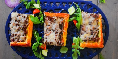 An Onion and Gruyere puff pastry tart served with a simple salad and  mustard dressing