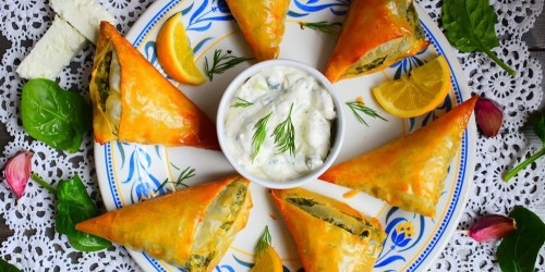 A Greek starter of spinach and feta filo parcels with Tzatziki