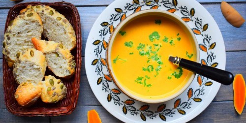 Spicy roast butternut squash soup served with crusty rolls